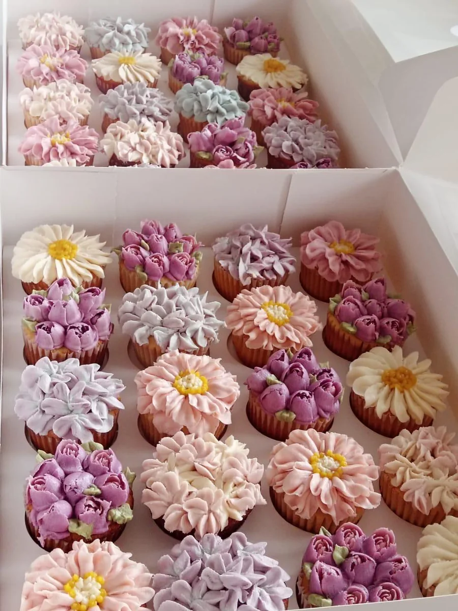 Boxes of floral buttercream cupcakes for corporate gifting