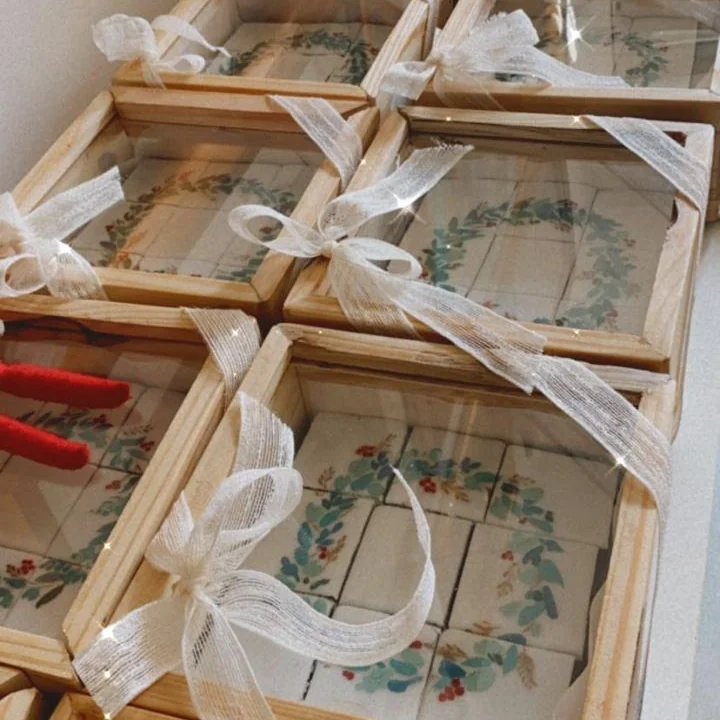 Wooden gift boxes of hand-painted shortbread truffles, tied with ribbon