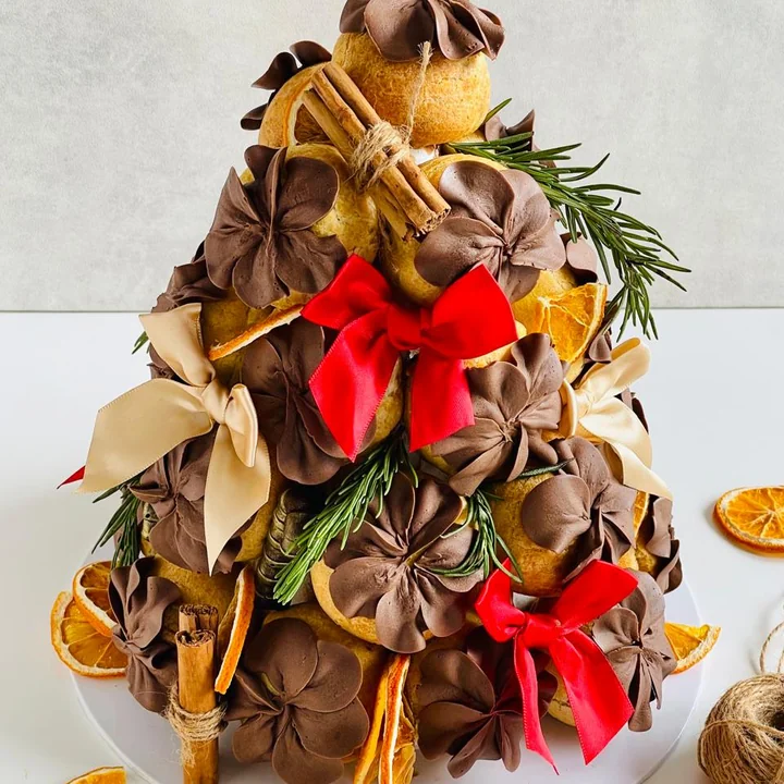 A chocolate profiterole tower with orange and cinnamon