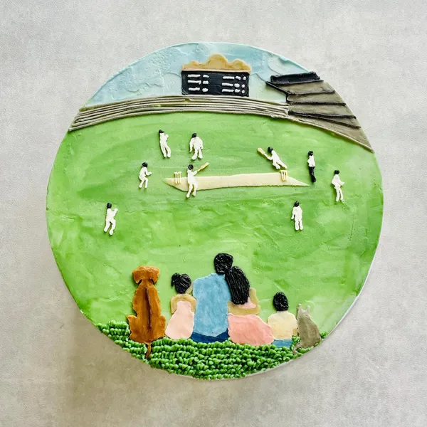 A hand-painted cricket match on a cake