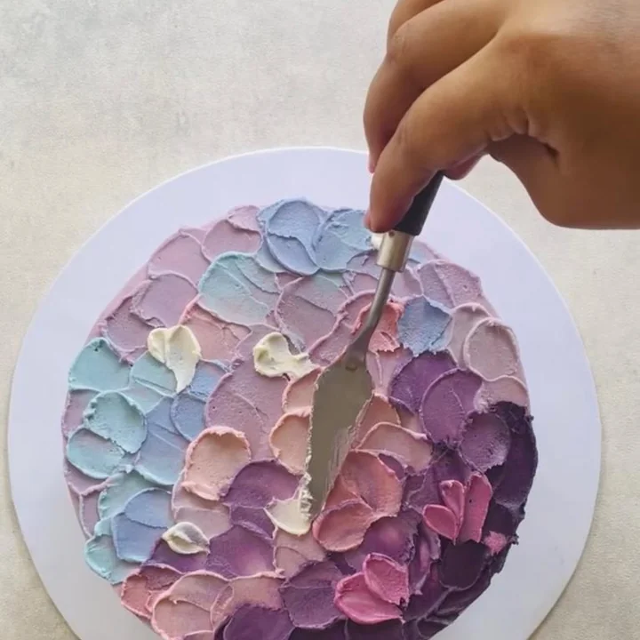 Sculpting a textured floral cake with a palette knife
