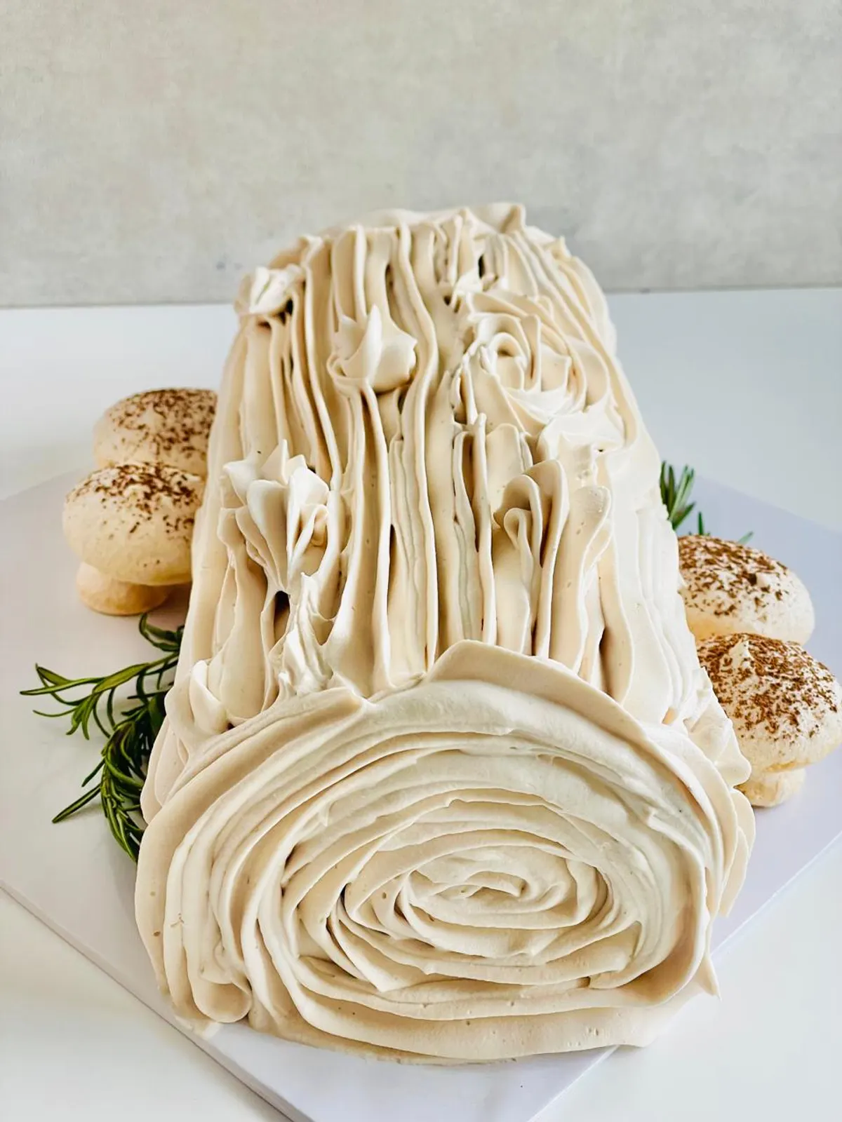 An Irish Bûche de Noël yule log, finished with cream and meringue mushrooms